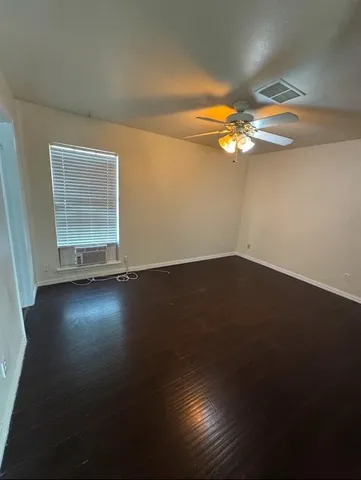 a view of room with hardwood floor and ceiling fan