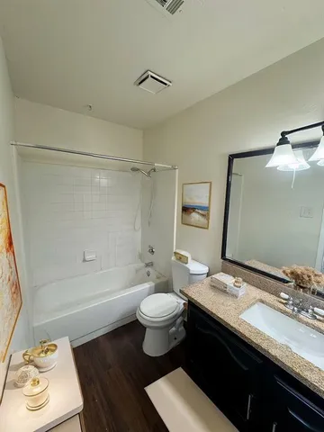 a bathroom with a sink toilet vanity and shower