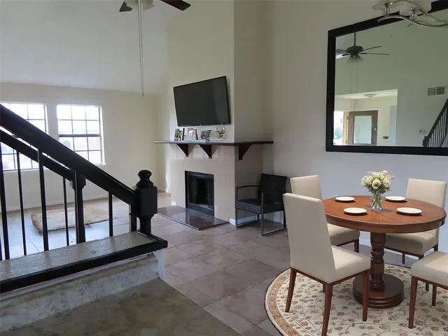 a living room with furniture a flat screen tv and a window