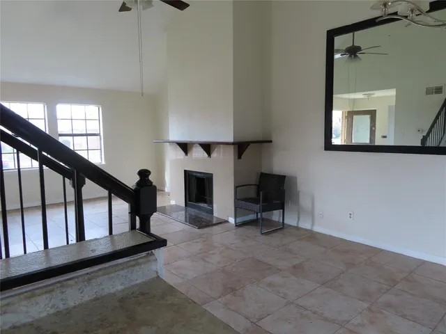 a view of staircase with furniture and a window