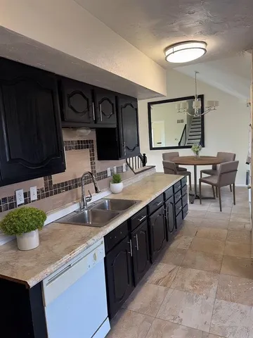 a large kitchen with lots of counter space and a sink