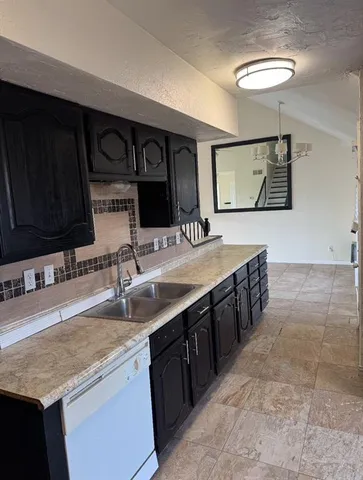 a kitchen with stainless steel appliances granite countertop a sink and a counter space
