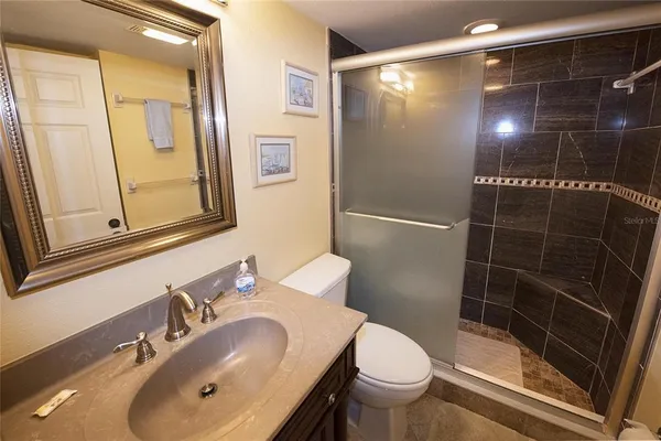 a bathroom with a sink toilet and shower