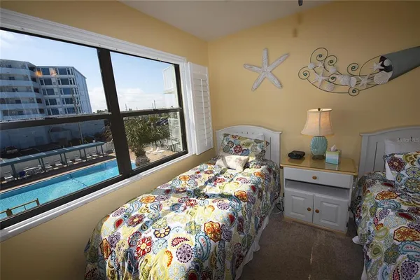 a bed sitting in a bedroom next to a window