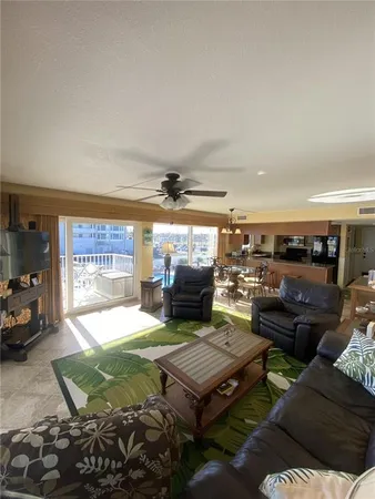 a living room with lots of furniture and kitchen view