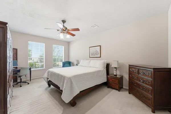 a bedroom with a bed and a desk