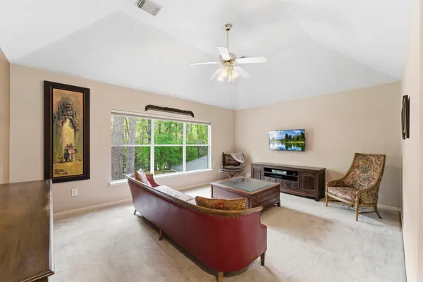 a living room with furniture and a chandelier