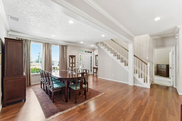 a view of a dining room with furniture window and wooden floor