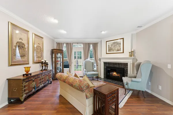 a living room with furniture a fireplace and a large window