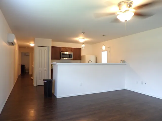 a view of a kitchen with a sink and a refrigerator
