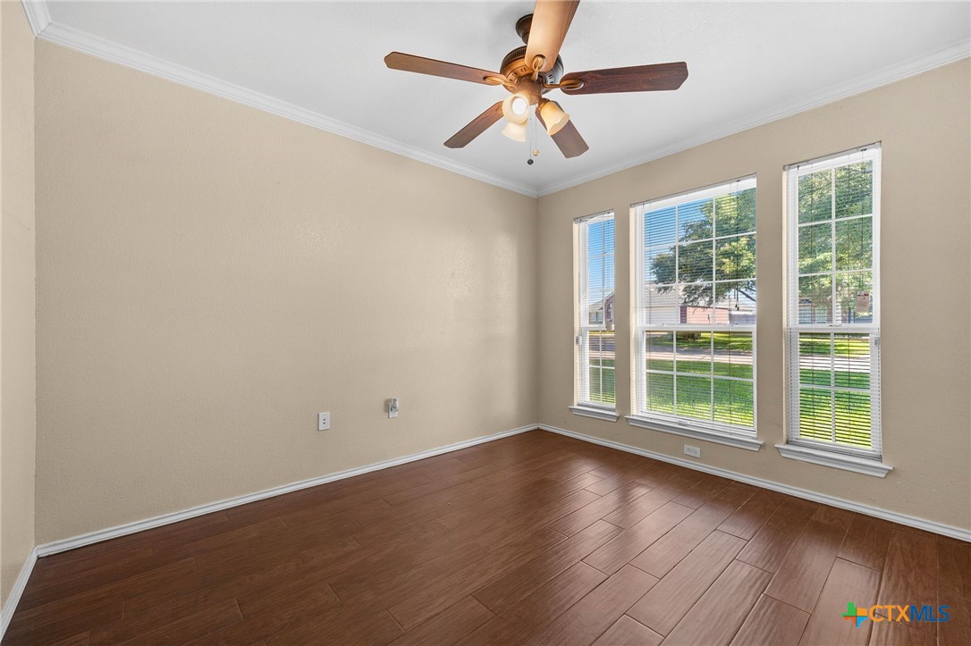 910 Neuberry Cliffe Temple, TX 76502 - Photo 21 of 32 an empty room with wooden floor and windows