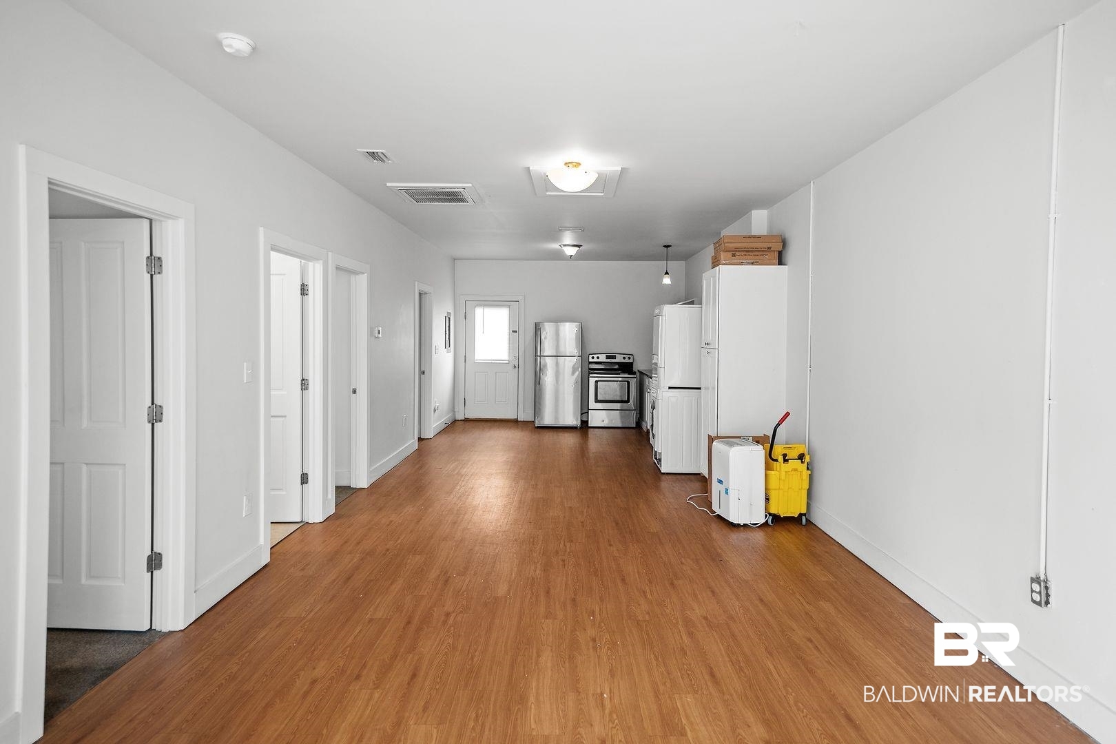 635 East Azalea Avenue Foley, AL 36535 - Photo 14 of 18 Open-concept interior featuring wood-finish flooring, white walls, and a recessed lighting fixture