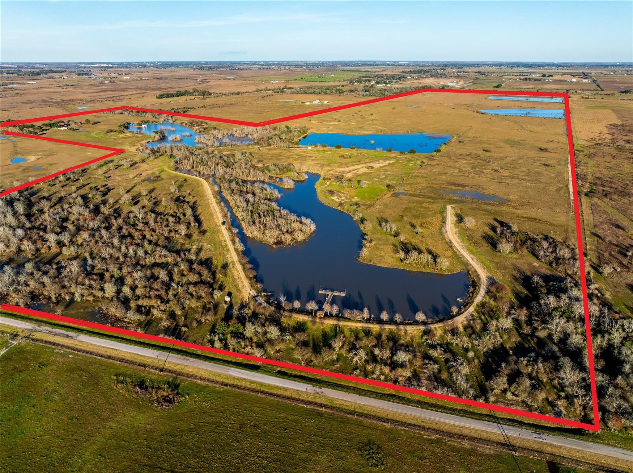 36067 Repka Road Waller, TX 77484 - Photo 2 of 14 This is true Texas living at its finest. Nature lovers & outdoor enthusiasts will fall in love with the land’s features: A 30-acre private lake, three duck ponds (ranging from 1-3 acres), boat house, gazebo, & dock for lakeside enjoyment, fishing pond near the home with its own deck, barn/shop, trap field & shooting station, road frontage on both Repka Road (gated entrance) and Schmidt Road.
