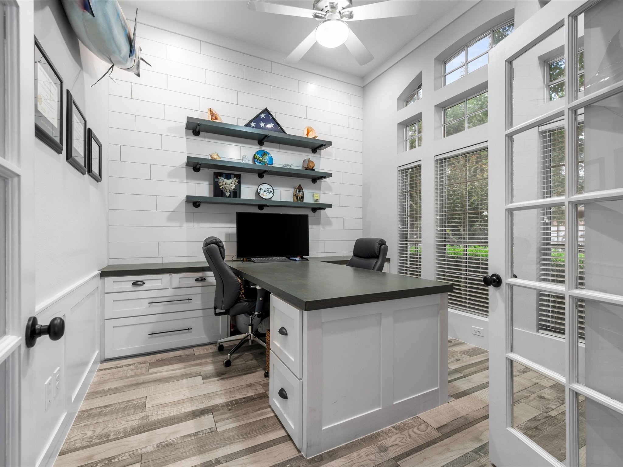 5910 Center Ct Drive Spring, TX 77379 - Photo 9 of 50 Completely redesigned in 2020, the home office is designed with both style and function in mind featuring wood-look tile flooring, expansive windows, and custom built-in desks that create a polished and productive workspace.