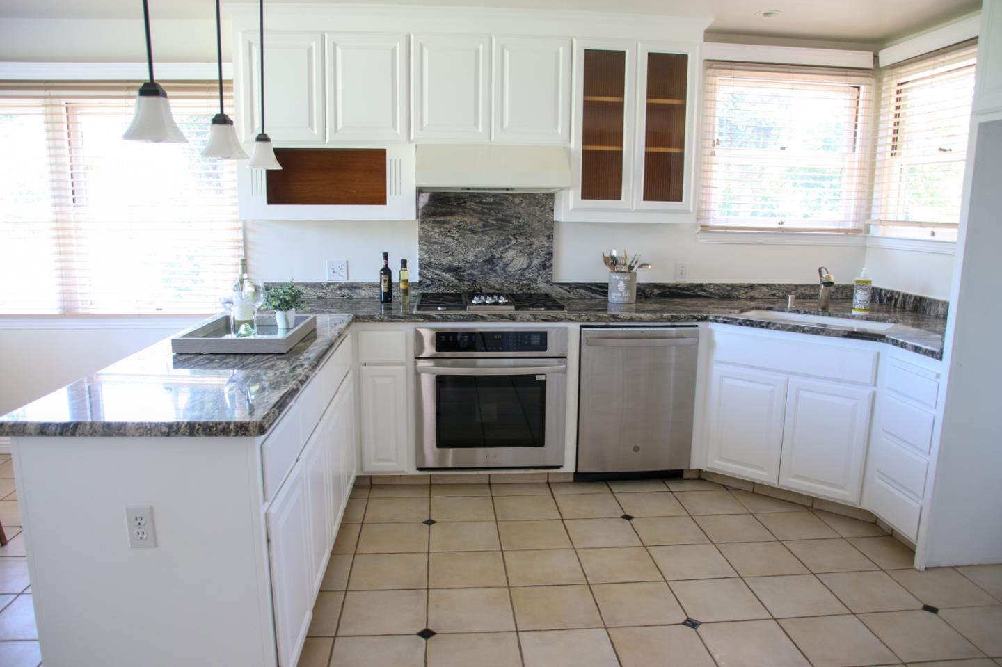 747 North 18th Street San Jose, CA 95112 - Photo 14 of 39 a kitchen with stainless steel appliances granite countertop a stove a sink and a microwave