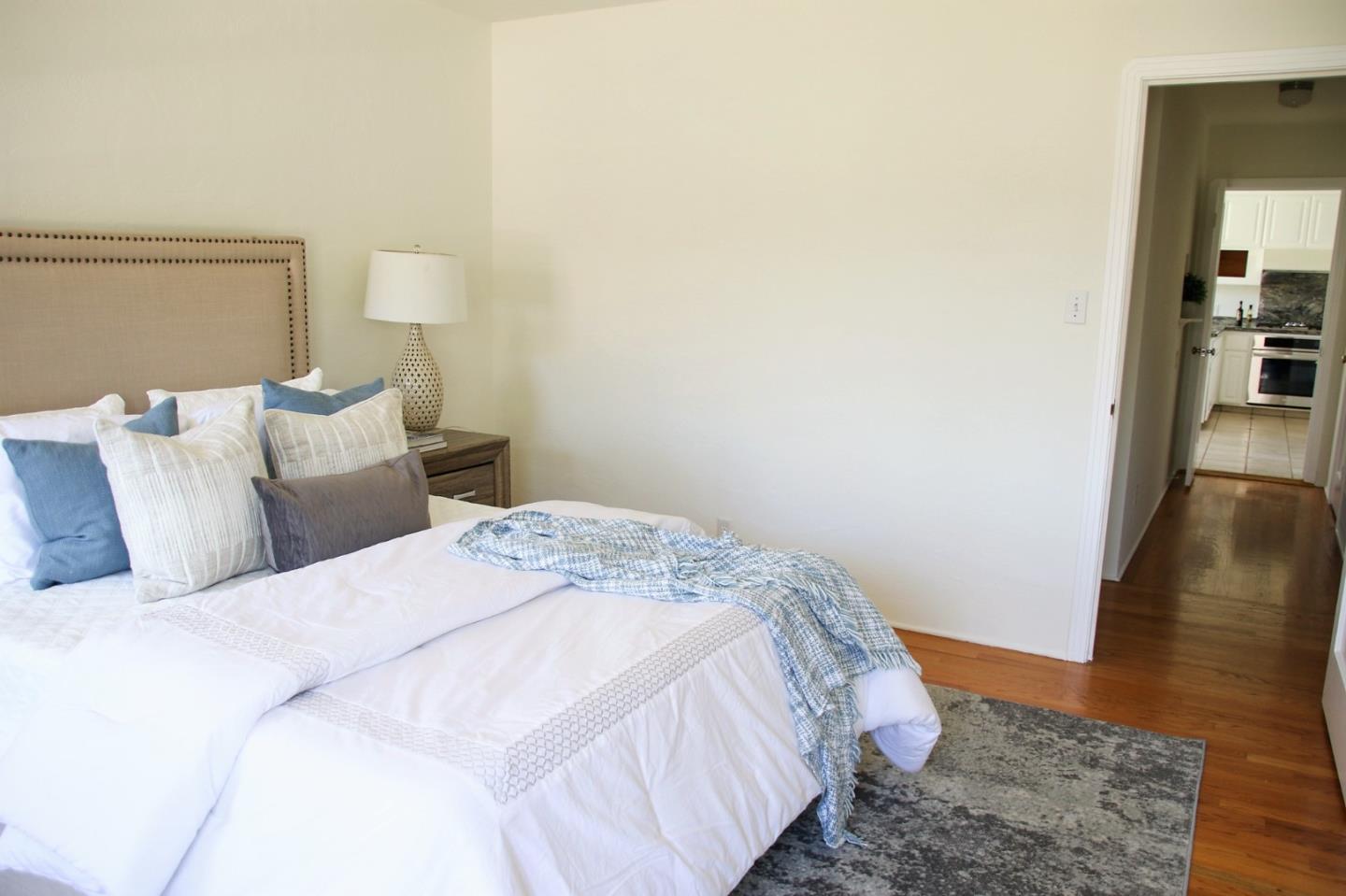 747 North 18th Street San Jose, CA 95112 - Photo 20 of 39 a bedroom with a bed and wooden floor