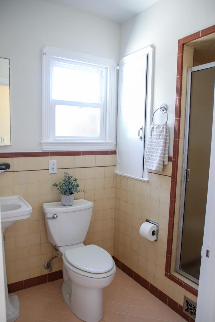 747 North 18th Street San Jose, CA 95112 - Photo 29 of 39 a bathroom with a toilet a sink and a mirror