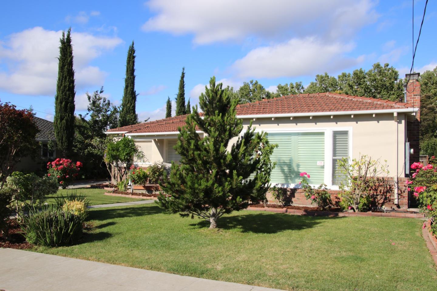 747 North 18th Street San Jose, CA 95112 - Photo 3 of 39 a front view of a house with a yard and potted plants