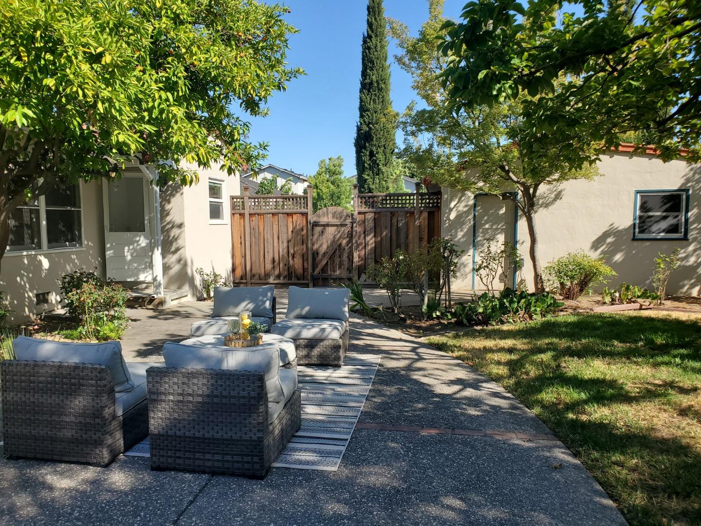 747 North 18th Street San Jose, CA 95112 - Photo 36 of 39 a view of a backyard with couches and a fire pit and large trees