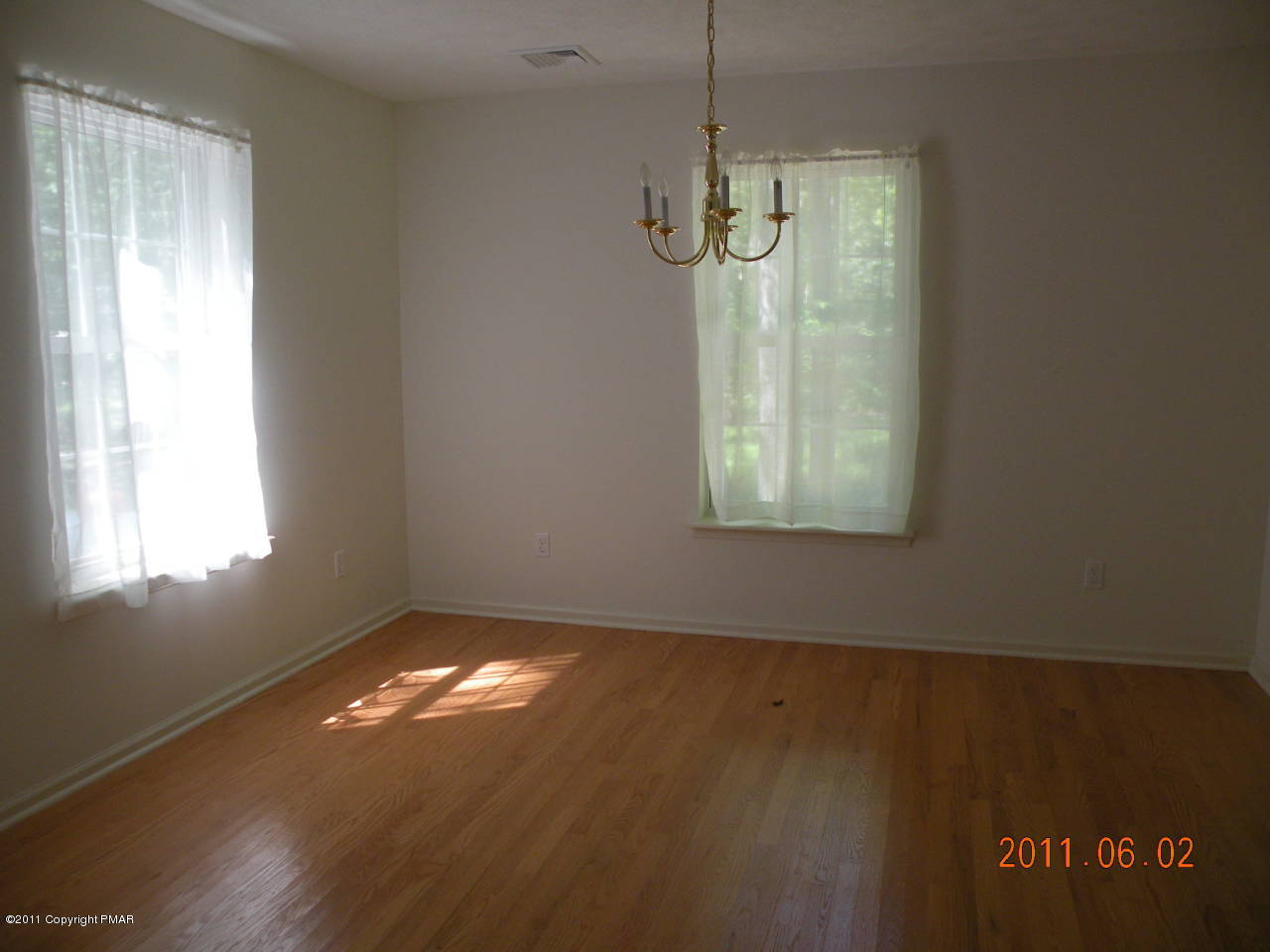 315 Red Run Road Pocono Summit, PA 18346 - Photo 3 of 10 a view of an empty room with wooden floor and a window