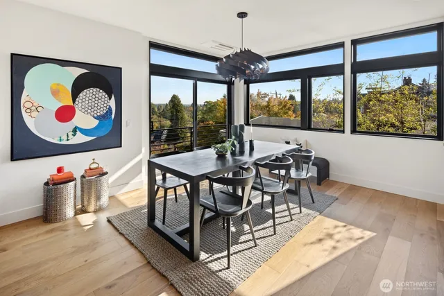 a view of a dining room with furniture and wooden floor