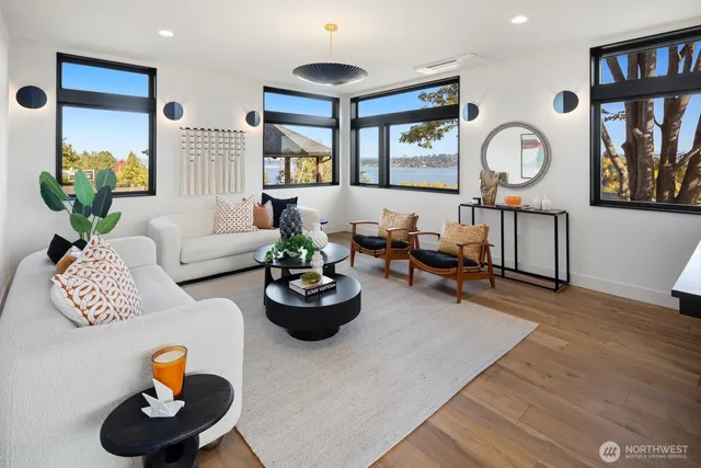 a living room with furniture and a wall painting