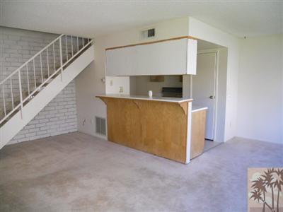 72644 Raven Road, Unit 3 Palm Desert, CA 92260 - Photo 3 of 11 a view of a livingroom with an empty space and a fireplace