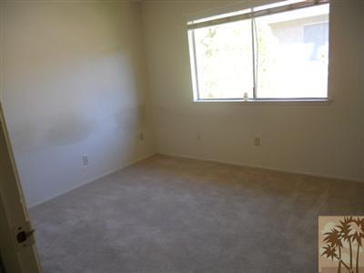 72644 Raven Road, Unit 3 Palm Desert, CA 92260 - Photo 8 of 11 an empty room with a window