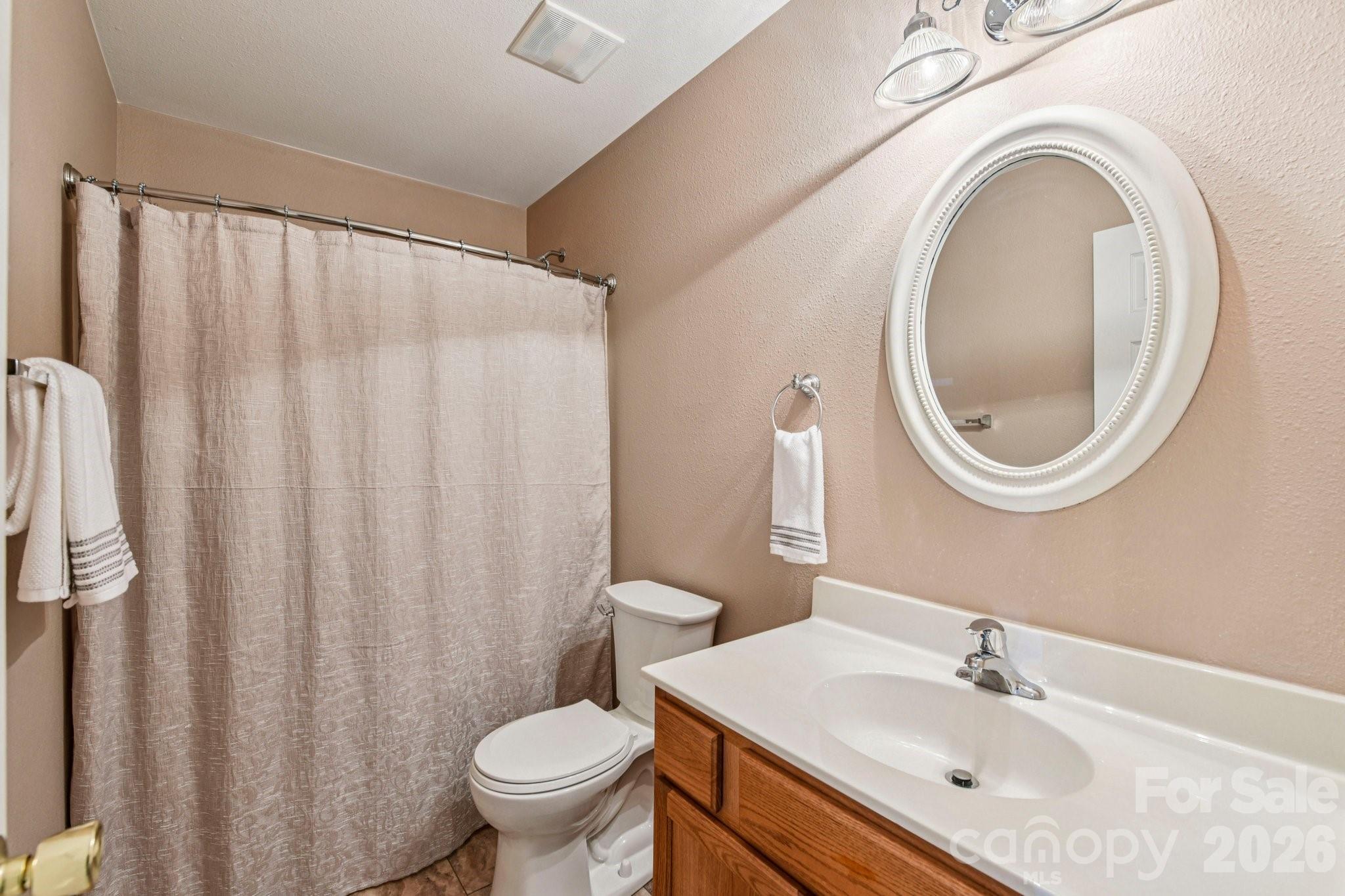 3741 Capris Lane Fort Mill, SC 29707 - Photo 14 of 22 a bathroom with a sink a mirror a toilet and a mirror