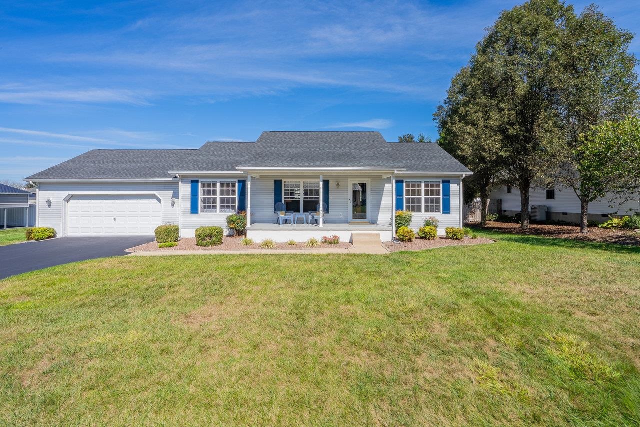 a front view of a house with a yard table and chairs