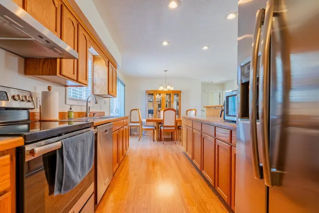 a kitchen with stainless steel appliances granite countertop a stove and a sink