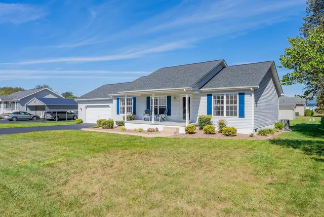 a front view of a house with swimming pool having outdoor seating