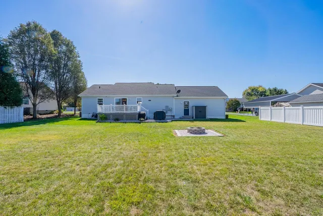 a view of house with backyard and swimming pool