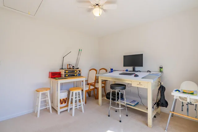 a view of a chairs and table on the roof deck