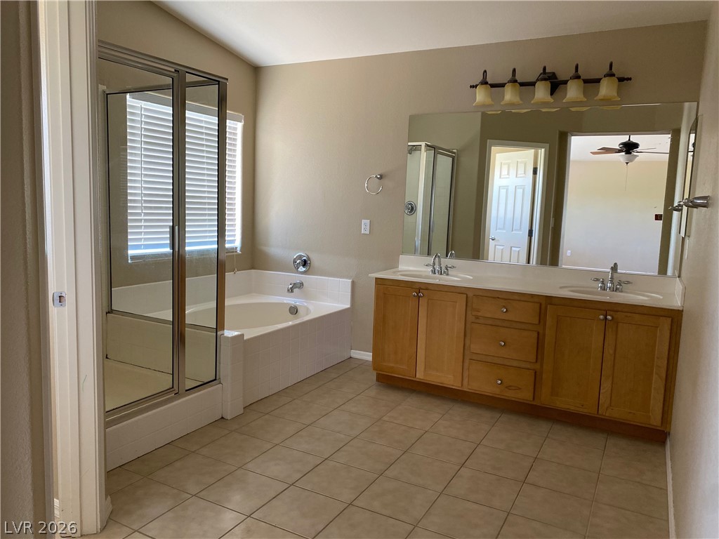 489 Foster Springs Road Las Vegas, NV 89148 - Photo 14 of 30 Indulge in a generously proportioned primary bathroom, offering a separate shower and a soothing soaking tub.