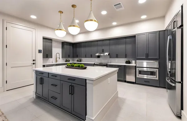 a kitchen with cabinets and stainless steel appliances
