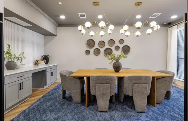 a kitchen that has a table and chairs in it