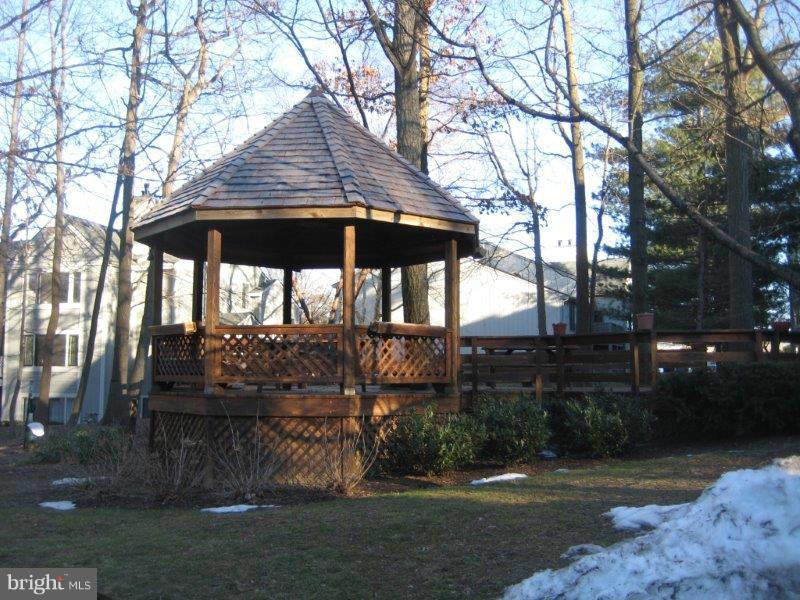 2226 Hunter's Run Drive, Unit 2226 Reston, VA 20191 - Photo 21 of 26 a view of a barn with a yard and a large tree