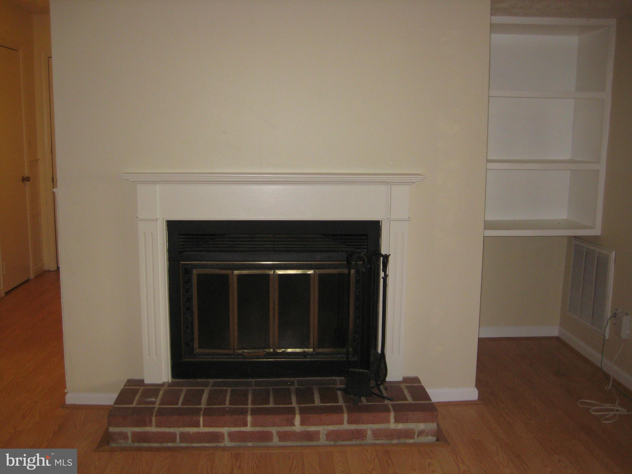 2226 Hunter's Run Drive, Unit 2226 Reston, VA 20191 - Photo 5 of 26 a living room with a fireplace and a walk in closet