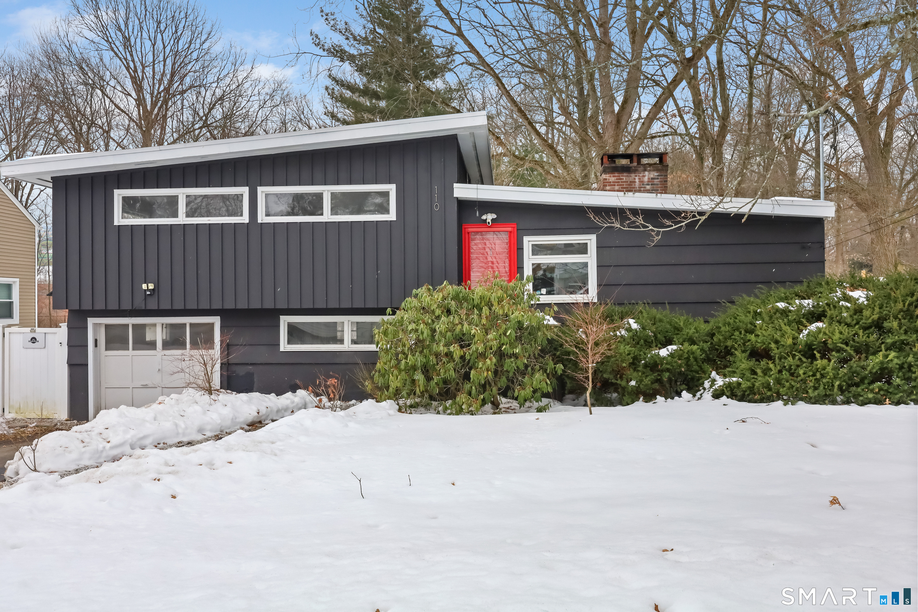 110 Corbin Road Hamden, CT 06517 - Photo 1 of 29 a front view of a house with a yard and garage