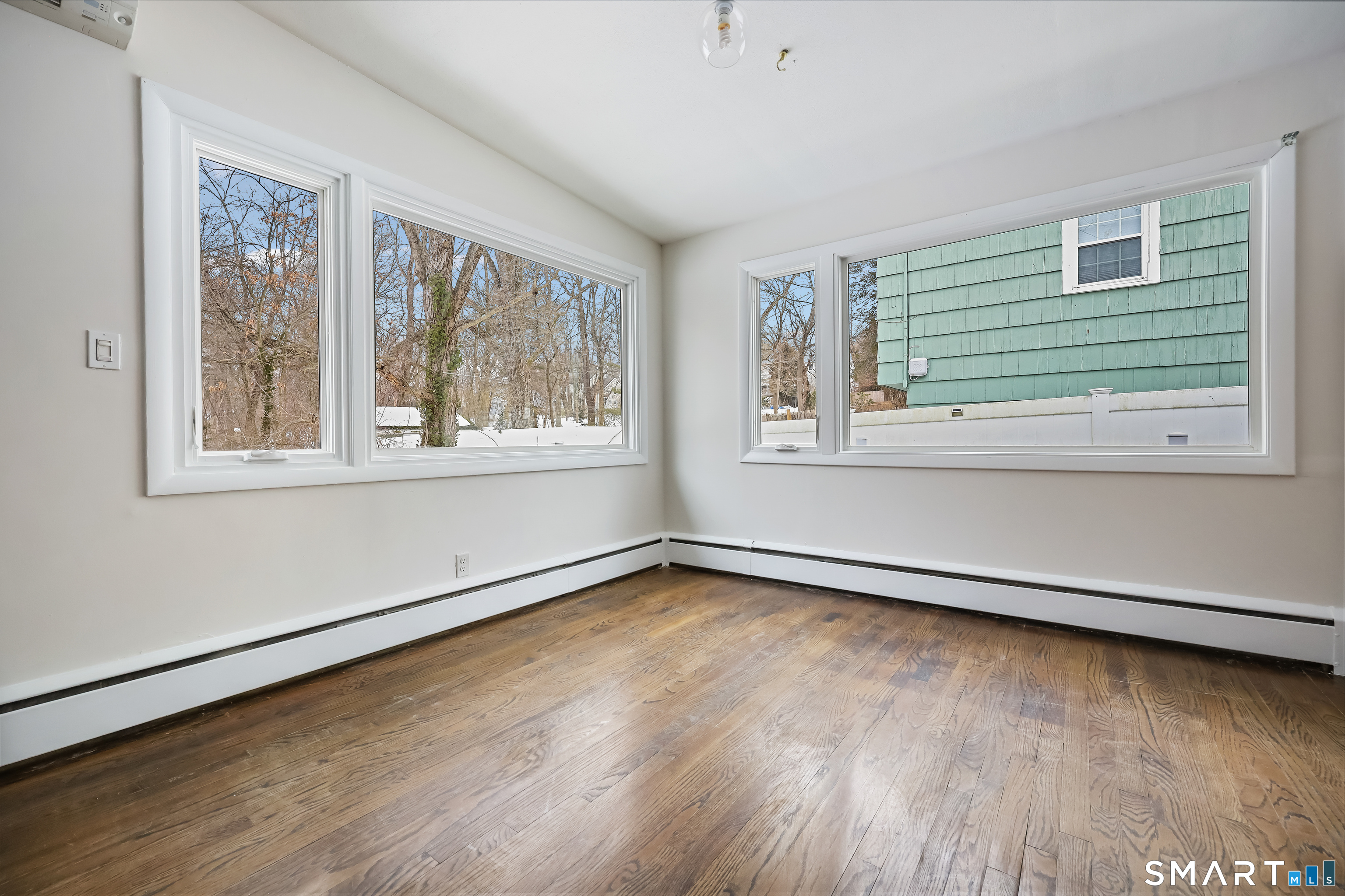 110 Corbin Road Hamden, CT 06517 - Photo 16 of 29 a view of an empty room with wooden floor and a window