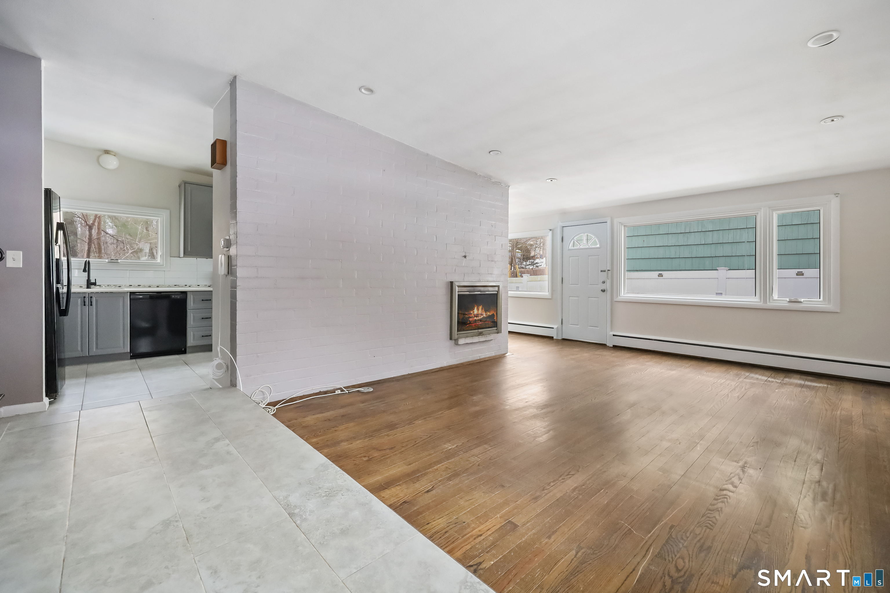 110 Corbin Road Hamden, CT 06517 - Photo 17 of 29 a view of empty room with kitchen and window