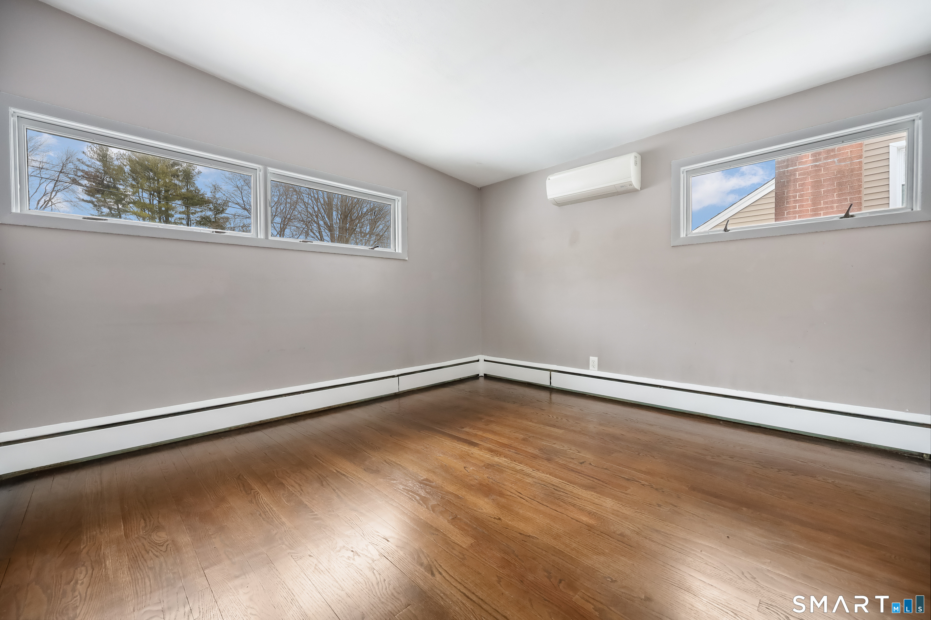110 Corbin Road Hamden, CT 06517 - Photo 19 of 29 a view of an empty room with wooden floor and a window