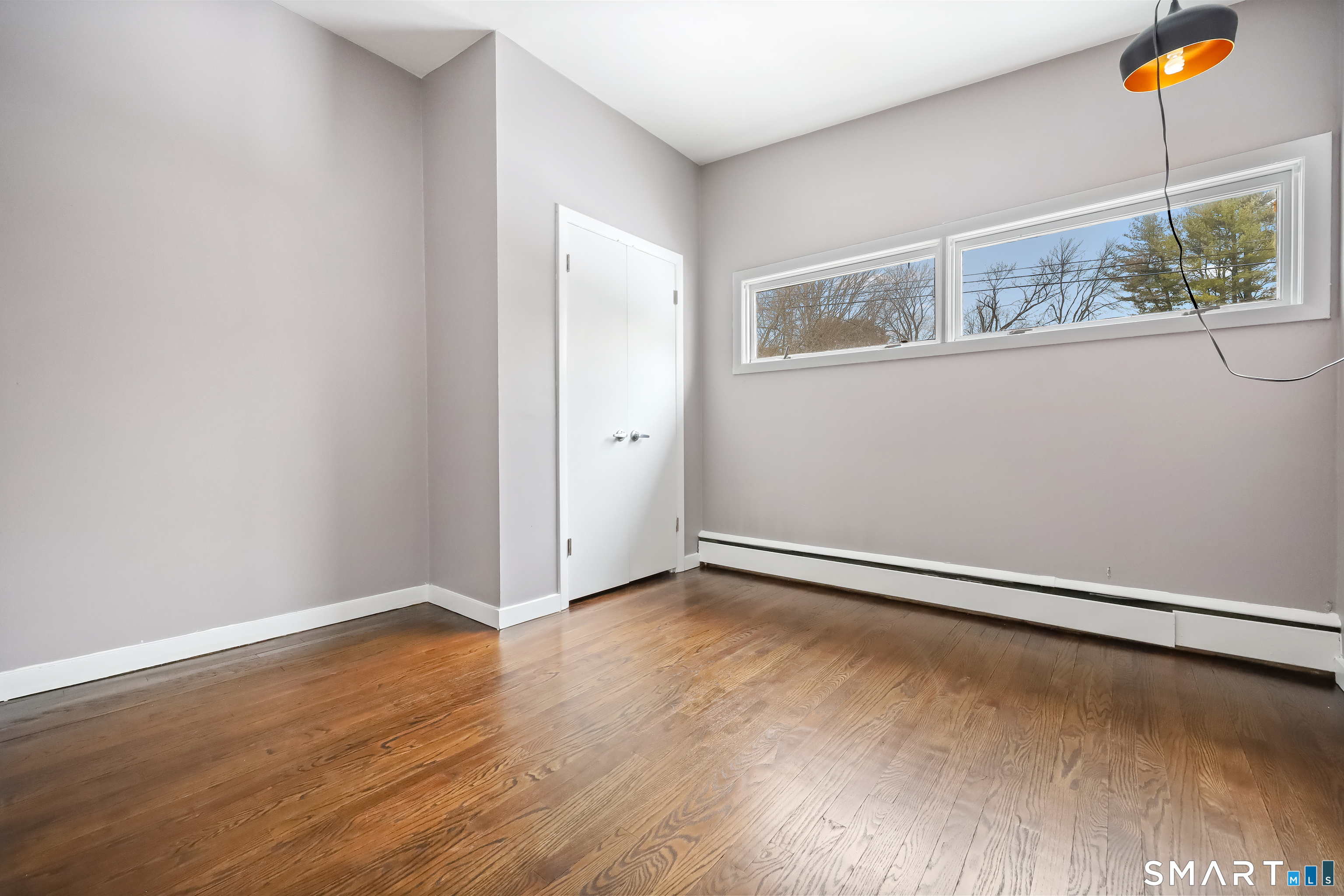 110 Corbin Road Hamden, CT 06517 - Photo 25 of 29 an empty room with wooden floor and window