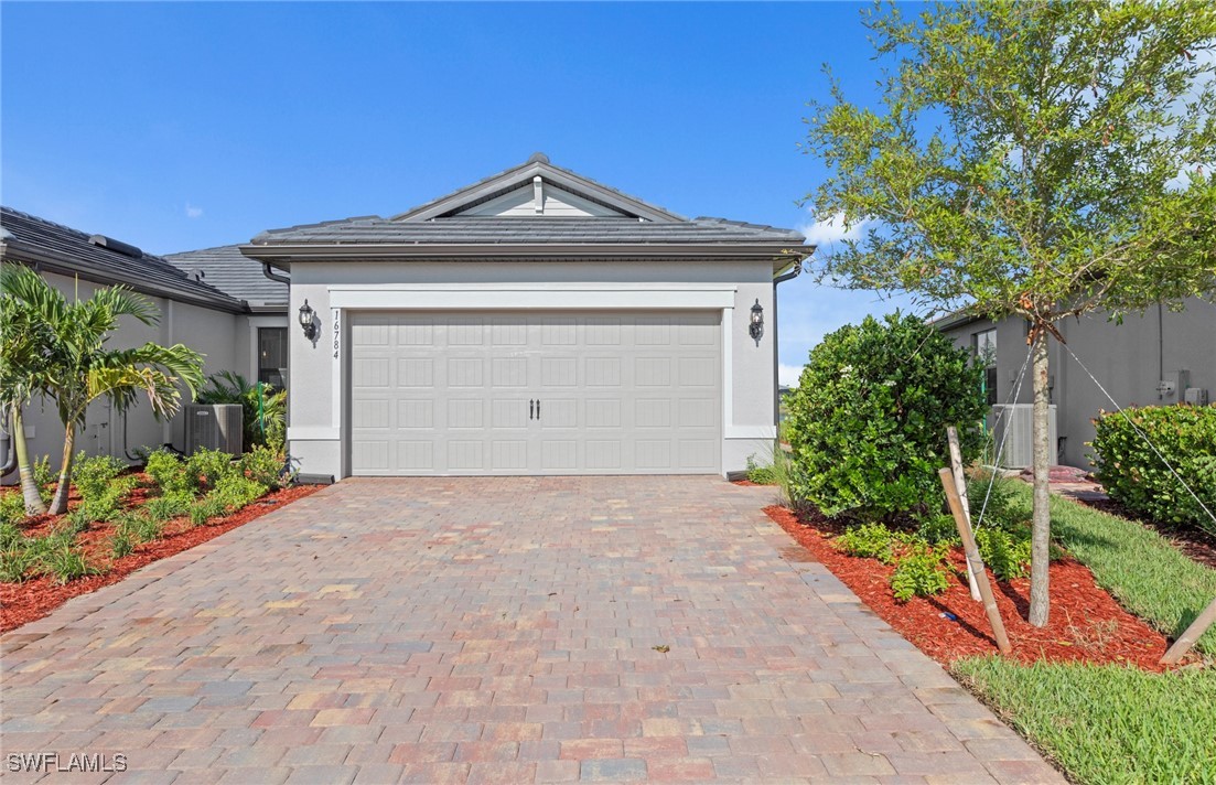 16784 Rolling Rock Boulevard Alva, FL 33920 - Photo 1 of 29 a front view of a house with a yard and garage