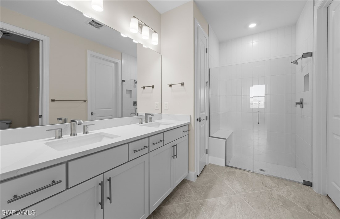 16784 Rolling Rock Boulevard Alva, FL 33920 - Photo 11 of 29 a spacious bathroom with a double vanity sink mirror and shower