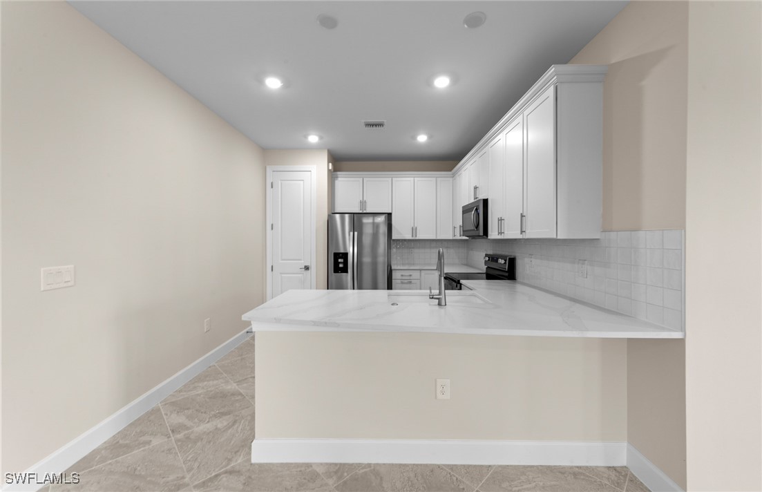 16784 Rolling Rock Boulevard Alva, FL 33920 - Photo 6 of 29 a view of a kitchen with wooden cabinets