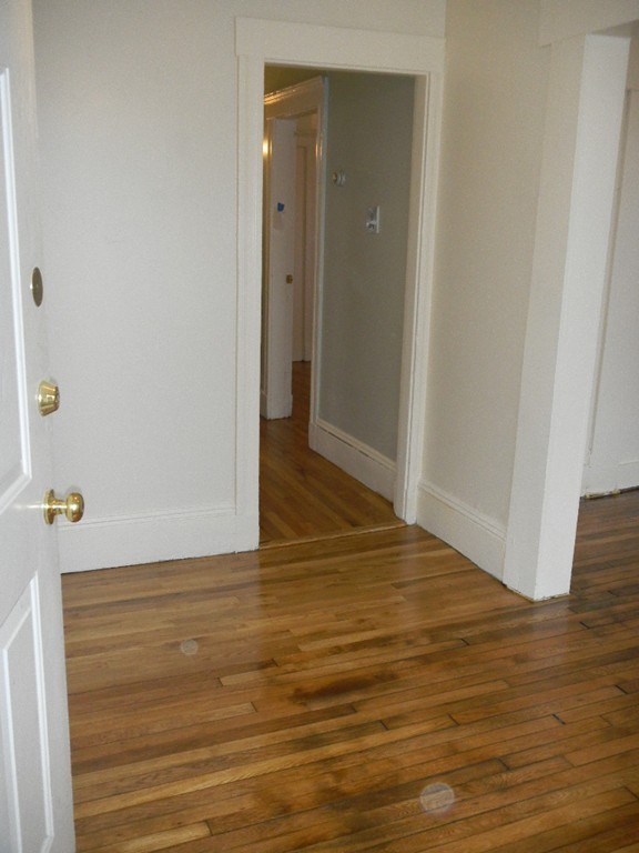 31 Iffley Road Boston, MA 02130 - Photo 16 of 21 a view of an empty room with wooden floor