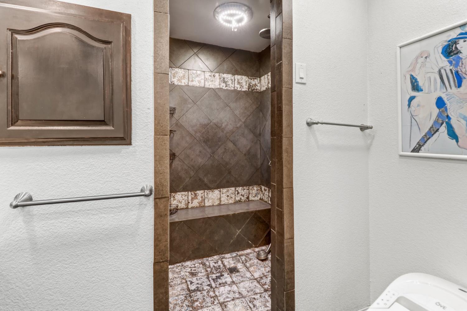 4330 Cavitt Stallman Road Granite Bay, CA 95746 - Photo 32 of 85 a bathroom with a bathtub and a shower