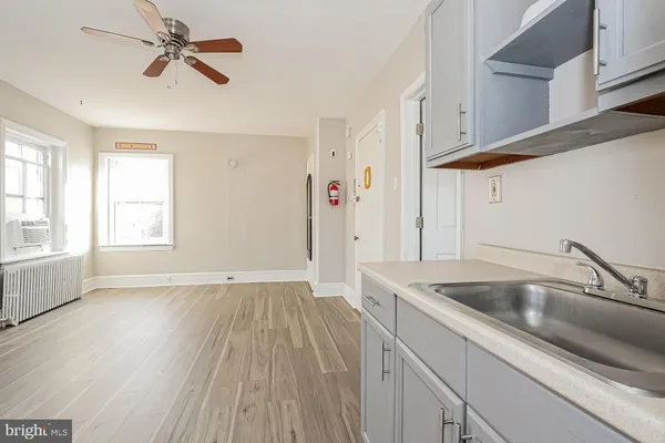 a view of a kitchen sink a window and stainless steel appliances